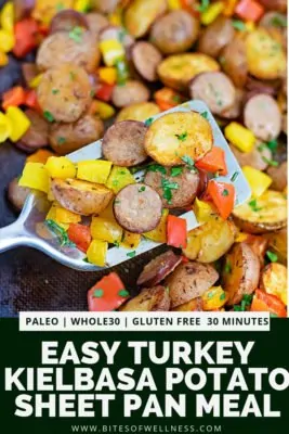 Silver spatula scooping up a serving of easy turkey kielbasa and potato sheet pan dinner with pinterest text on the bottom of the photo