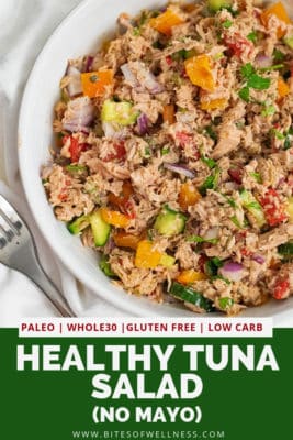 Overhead shot of a large bowl of healthy Mediterranean tuna salad (no mayo) with a fork to the left and pinterest text describing the dish on the bottom of the photo