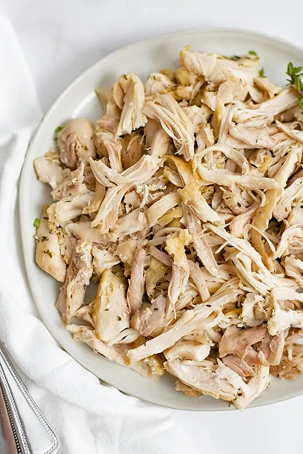 Large white plate filled with Instant Pot Shredded Chicken Thighs 