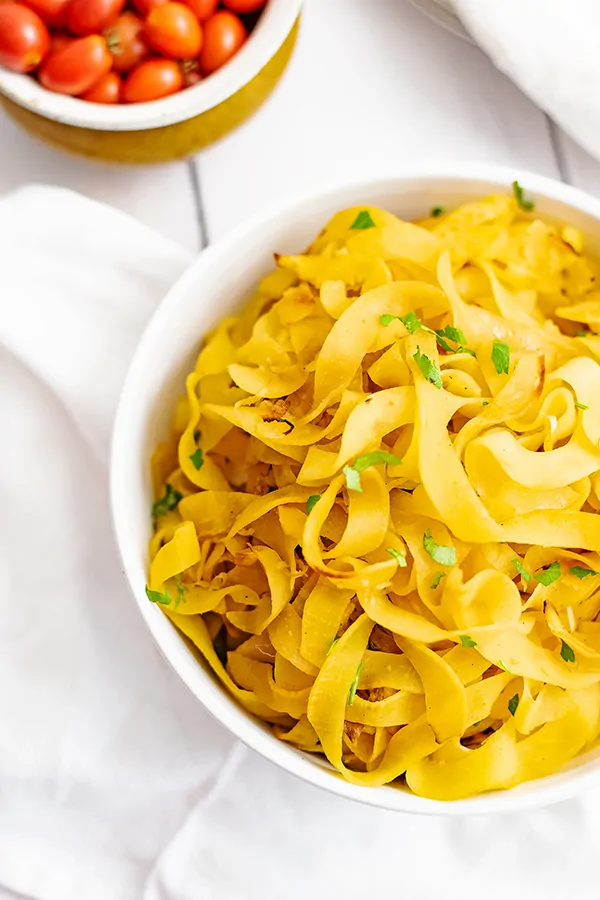 Overhead shot of large bowl filled with spiralized rutabaga recipe over a white napkin