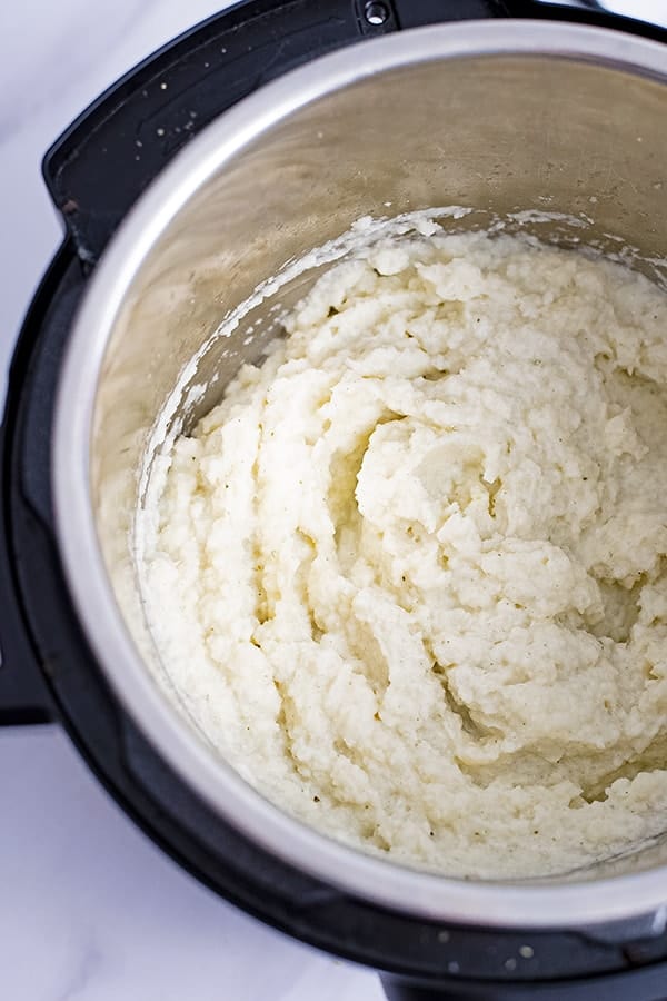 Overhead shot of an instant pot filled with vegan garlic mashed cauliflower