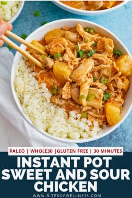 Overhead shot of large bowl of pressure cooker sweet and sour chicken thighs in the bowl next to cauliflower rice with chop sticks picking up a piece of chicken from the bowl. Pinterest text on the bottom of the photo