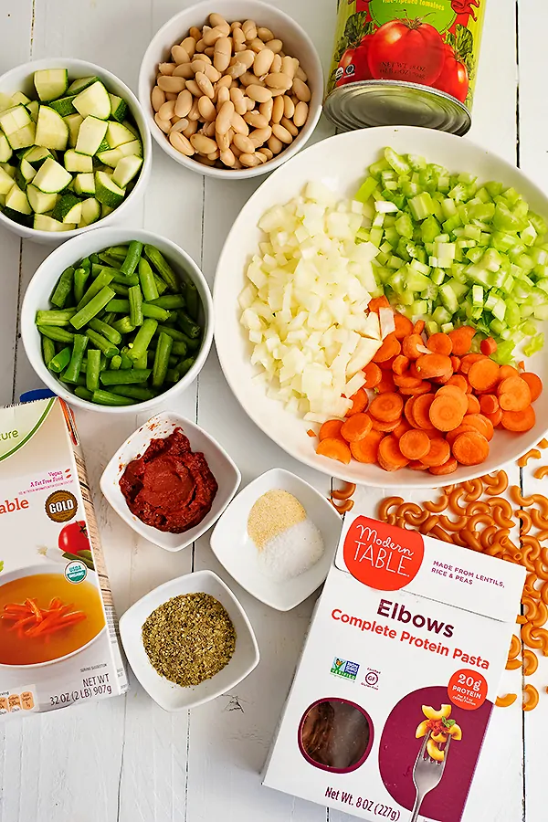 The ingredients for the vegan minestrone soup all on the table, before cooking