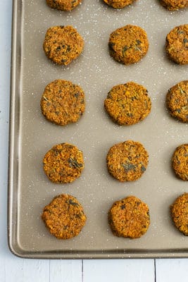 Sheet pan filled with sweet potato patties lined up on the sheet pan