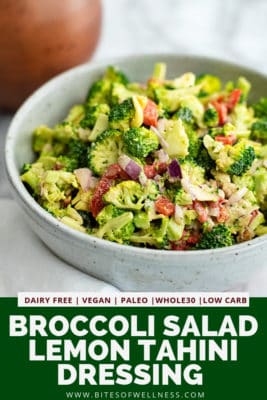 Large bowl filled with crunchy broccoli salad with lemon tahini dressing. Pinterest text on the bottom