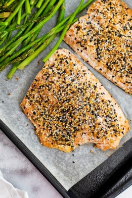 Close up overhead shot of cooked filet of everything bagel salmon on a baking sheet