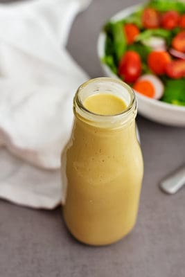 Overhead shot of bottle of homemade honey mustard dressing