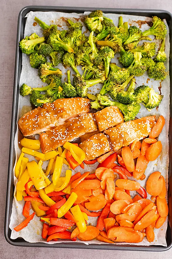 Overhead shot of teriyaki salmon and veggies on a sheet pan