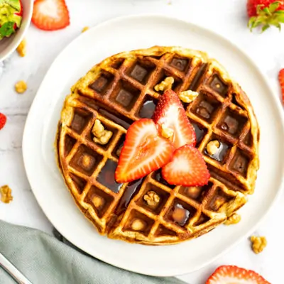 Protein waffle with sliced strawberries and chopped walnuts on top