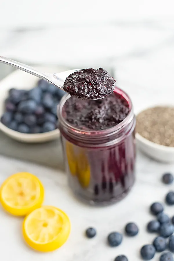 Blueberry Chia Jam with a spoon holding a scoop of jam