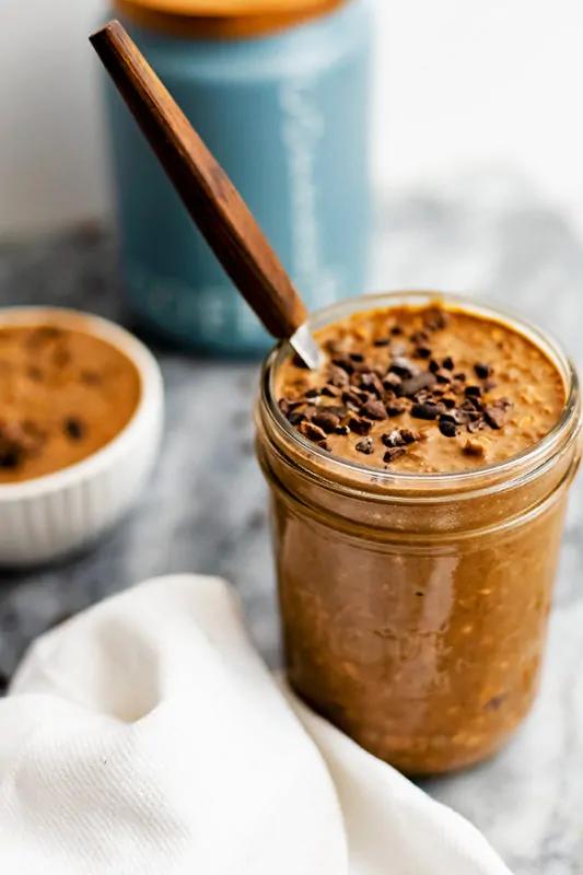 Jar of chocolate coffee overnight oats with white napkin