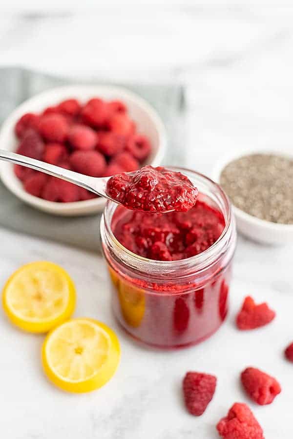 Raspberry Chia Jam with a spoon holding a scoop of jam