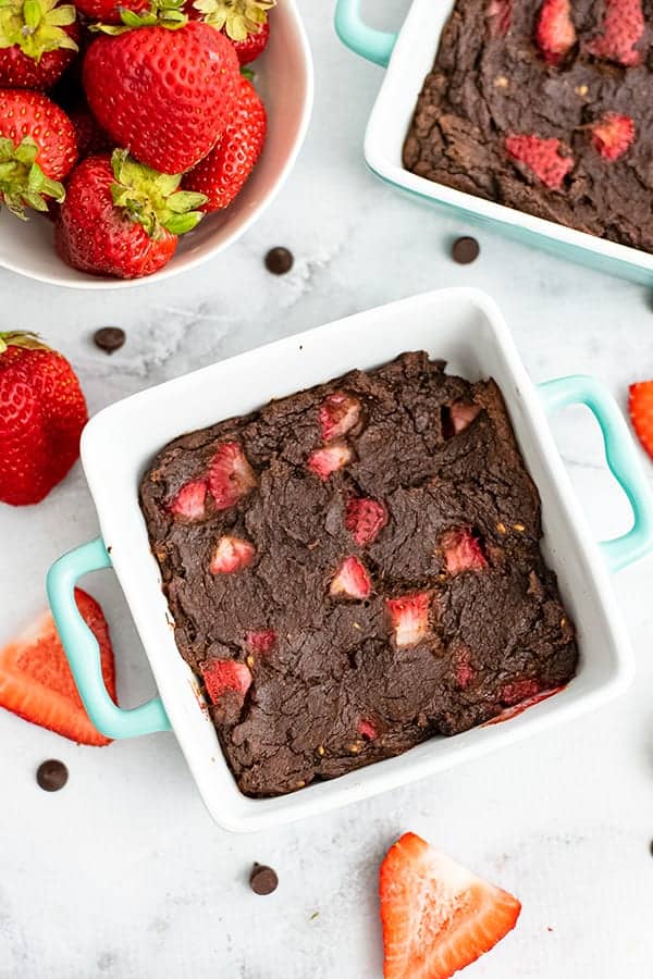 Square ramekin filled with a strawberry and chocolate brownie