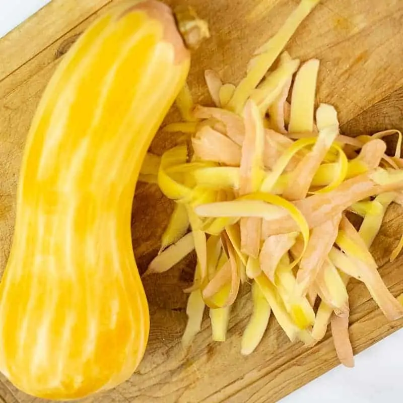 Peeled butternut squash on a cutting board