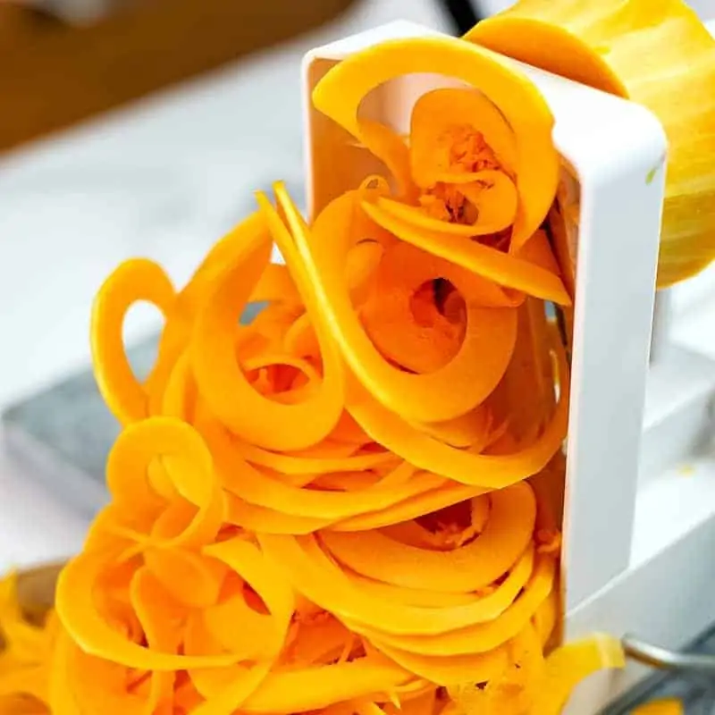 Butternut squash noodles being made on the spiralizer