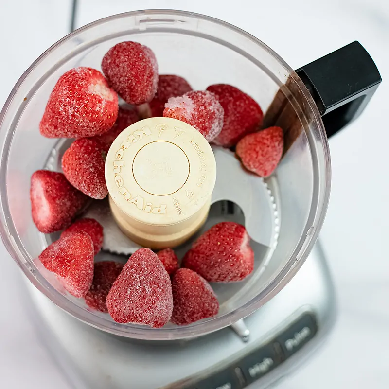 Frozen whole strawberries in the food processor