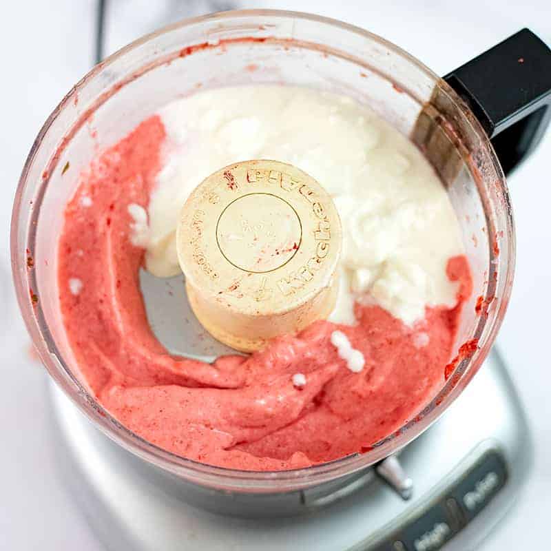 Yogurt added to the frozen strawberries and banana in food processor