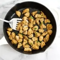 Skillet filled with Italian Chicken and a silver spatula