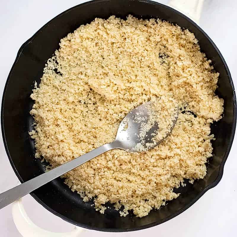 Cooked cauliflower rice in a cast iron skillet