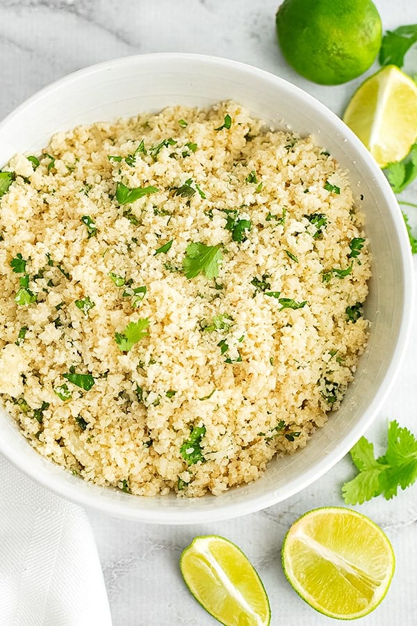 Large white bowl filled with cilantro lime cauliflower rice.