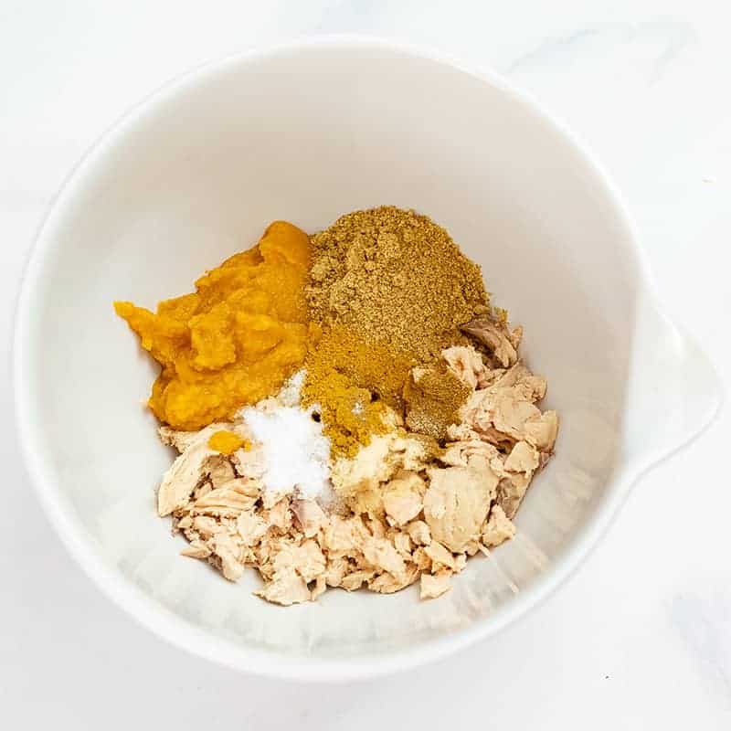 Large mixing bowl filled with canned salmon, flax, spices