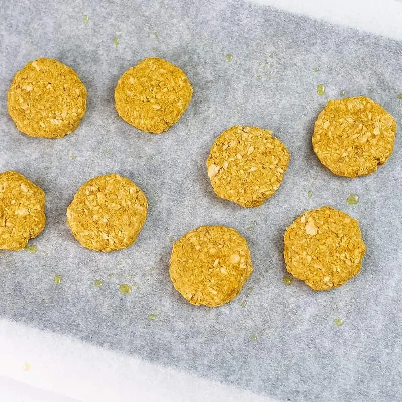 Curry salmon cakes on a parchment paper lined baking sheet