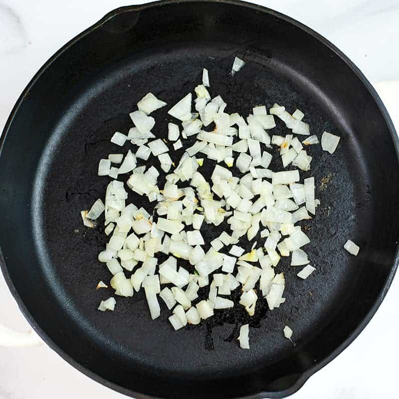 Chopped onions in a cast iron skillet