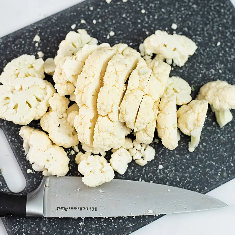 Chopped cauliflower on a cutting board.