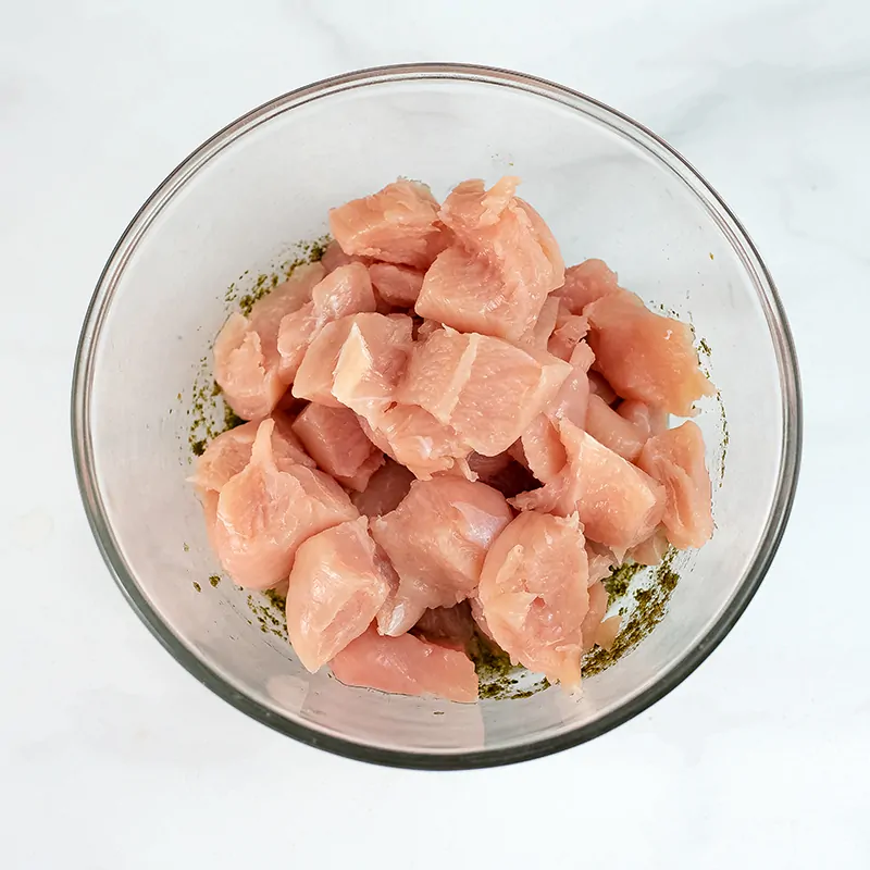 Large bowl filled with cubed chicken.