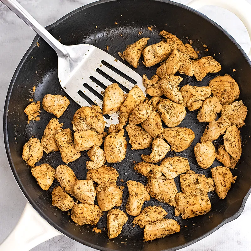 Cast iron filled with Italian chicken after cooking.