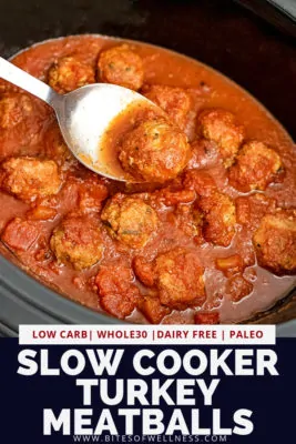 Crockpot of Whole30 slow cooker turkey meatballs with silver serving spoon