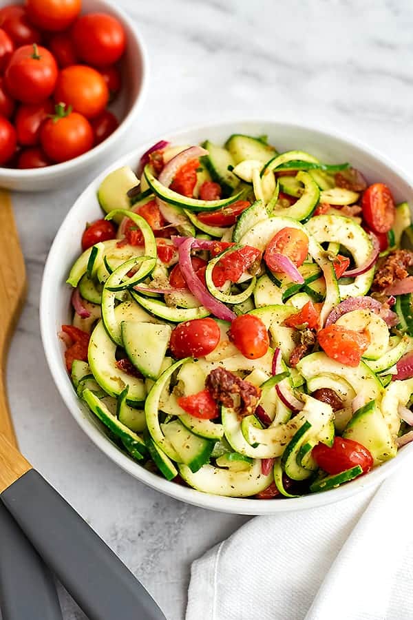 Large bowl of zucchini pasta salad with italian dressing