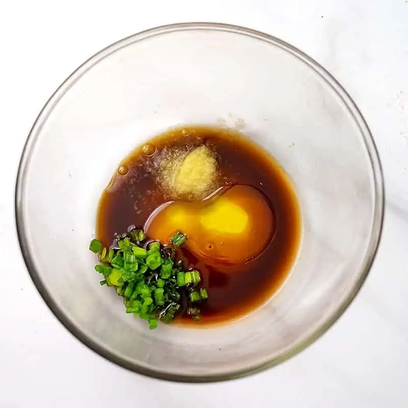 Glass bowl filled with Asian Marinade ingredients.