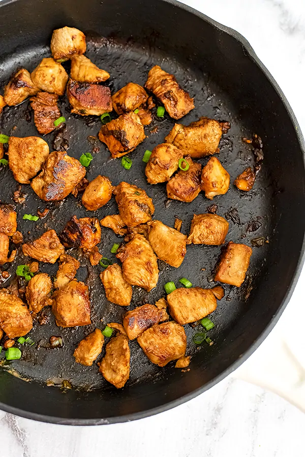 Large cast iron skillet filled with Asian Chicken.