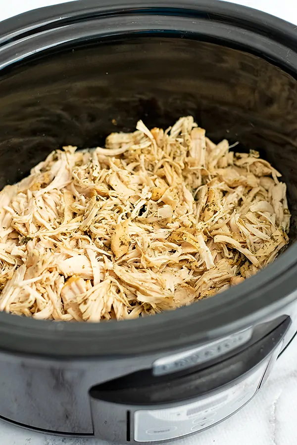 Crockpot filled with shredded ranch chicken.