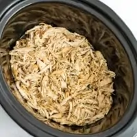 Crockpot filled with shredded ranch chicken.