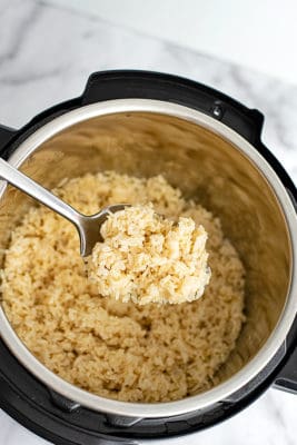 Large serving spoon of jasmine rice out of the instant pot.