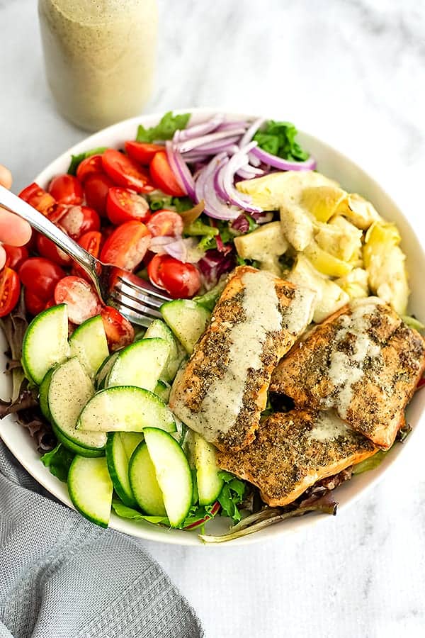 Fork in a bowl of italian salmon salad.
