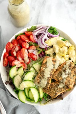 Large bowl of Italian Salmon Salad with dressing poured on top.
