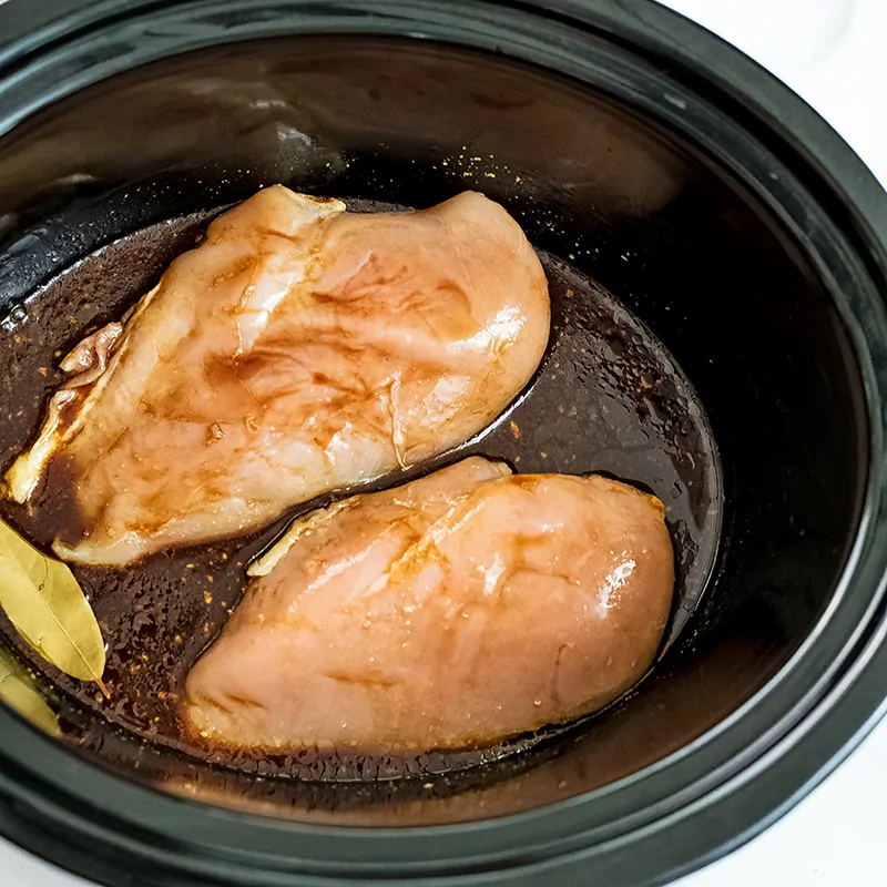 Raw chicken in the balsamic sauce in crock pot.