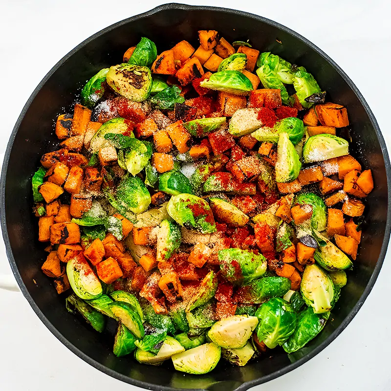 Spices over cooked brussels and sweet potatoes. 
