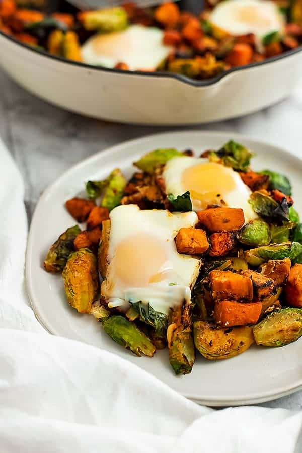 Plate full of sweet potato hash and 2 eggs. 