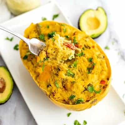 Fork holding a bite of creamy spaghetti squash bake.