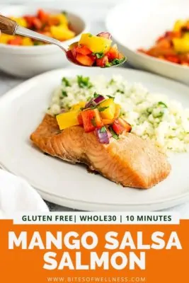 Salmon filet on a white plate with mango salsa spooning on top.