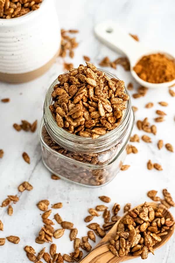 Glass jar filled with pumpkin spice sunflower seeds.