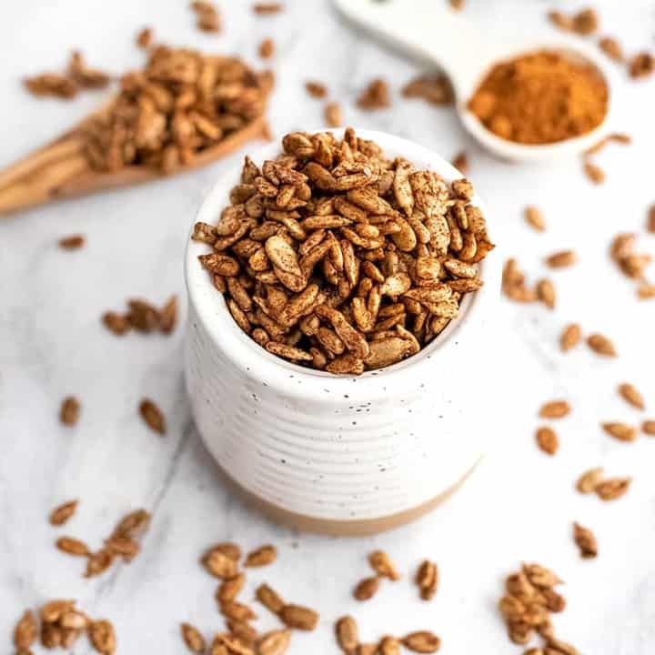 White jar filled with spiced sunflower seeds.