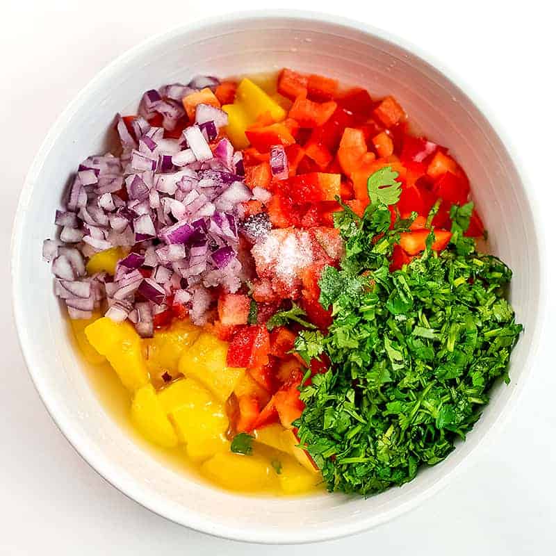 Mango salsa ingredients before stirring.