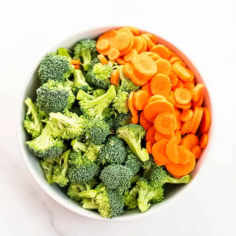 Bowl full of chopped broccoli and carrots.