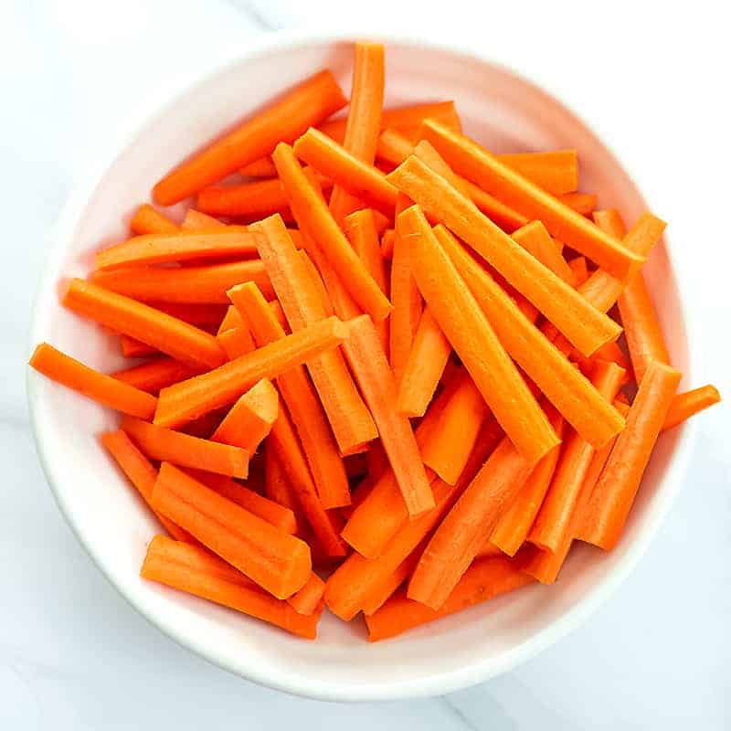 Bowl of carrot fries before baking.