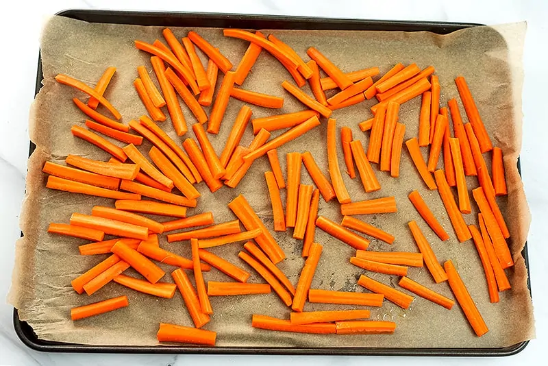 Carrot fries on baking sheet before cooking